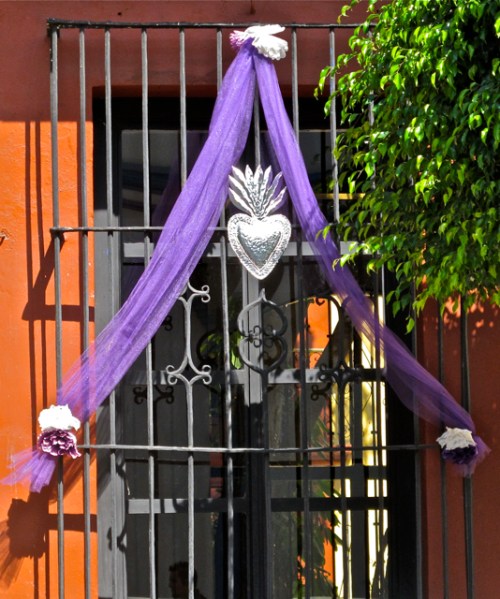 window decoration: purple tule, tin heart, and flowers