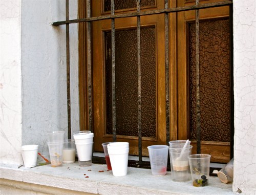 Empty cups on window sill