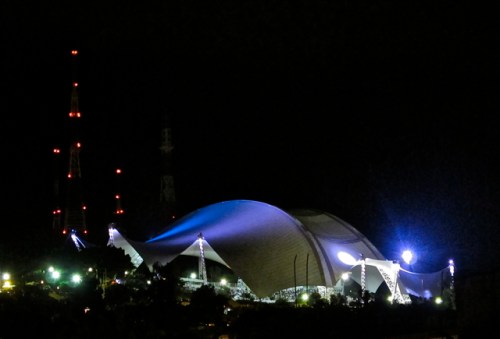 Guelaguetza Auditorium with lights glowing at night