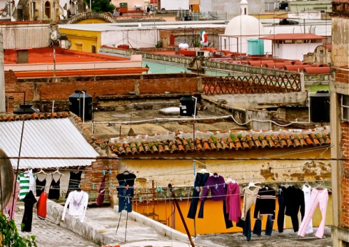 Laundry hanging from rooftop clothesline.
