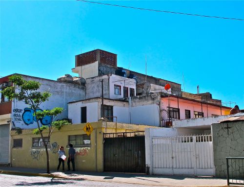 Concrete boxy buildings against clear blue sky.
