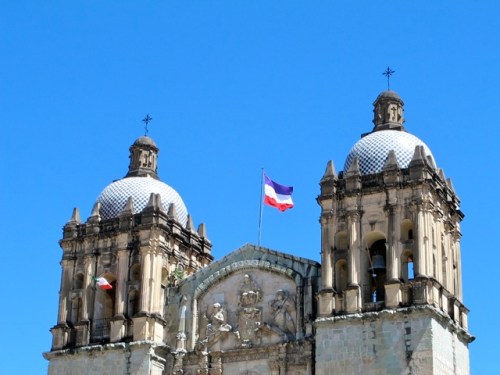 Purple, white, and red flag flying atop Santo Domingo 