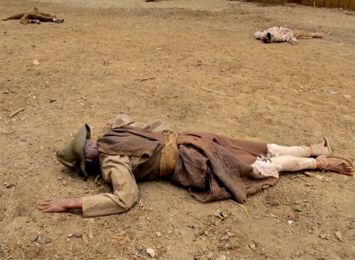 Three "dead" dummies on dirt street