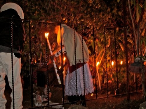 Elderly man and woman in cemetary with candles