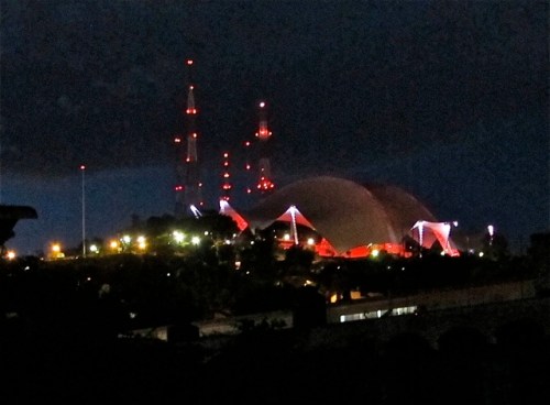 Guelaguetza auditorium glowing with red lights at night