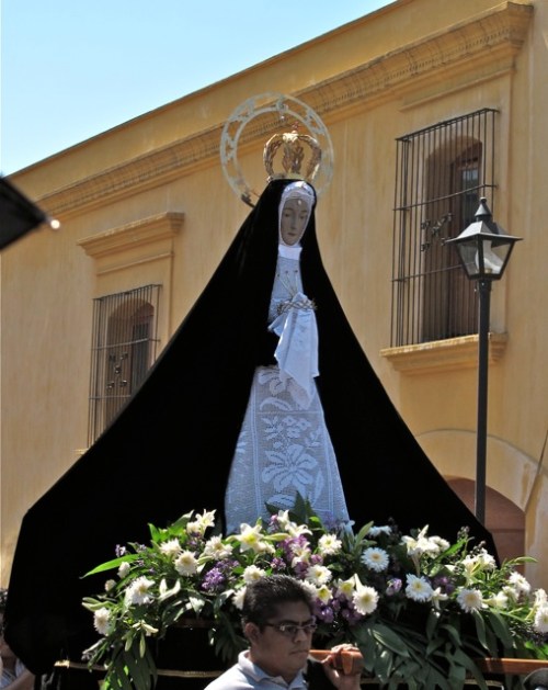 Virgen de La Soledad being carried through the streets with plain purple cape