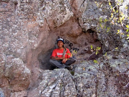 IMG_3508 Sam sitting cross-legged in a natural alcove in the mountain