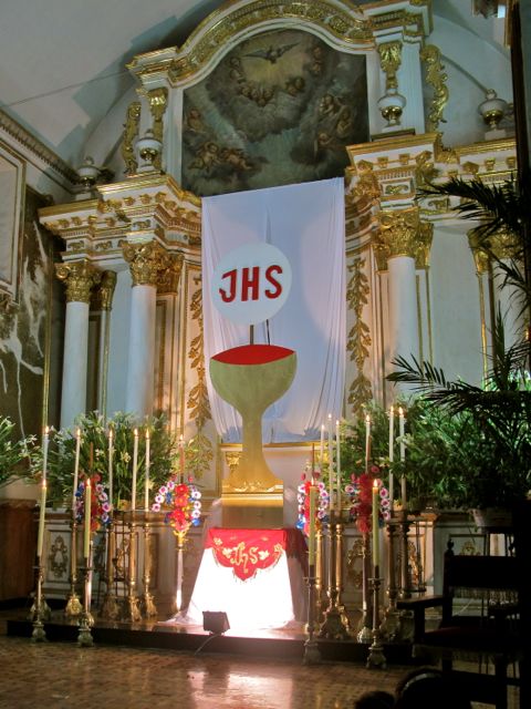 Altar with JHS on banner above altar