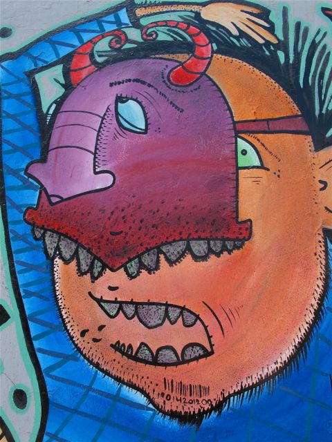 Close up of colorful street art face with mask.