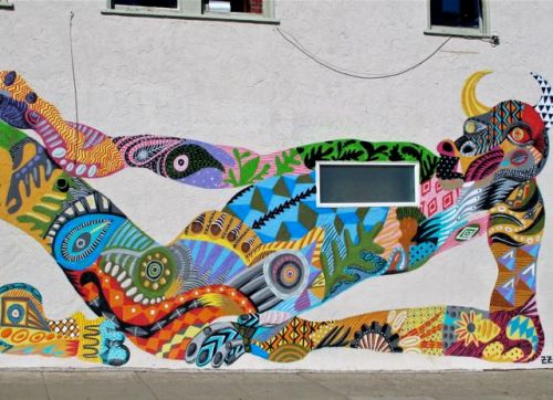 Reclining bull painted on side of wall