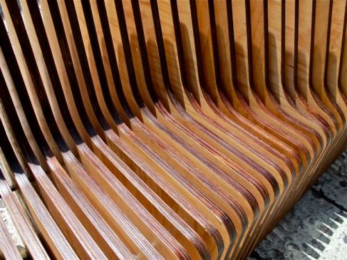 Slats of curved pieces of wood forming a bench