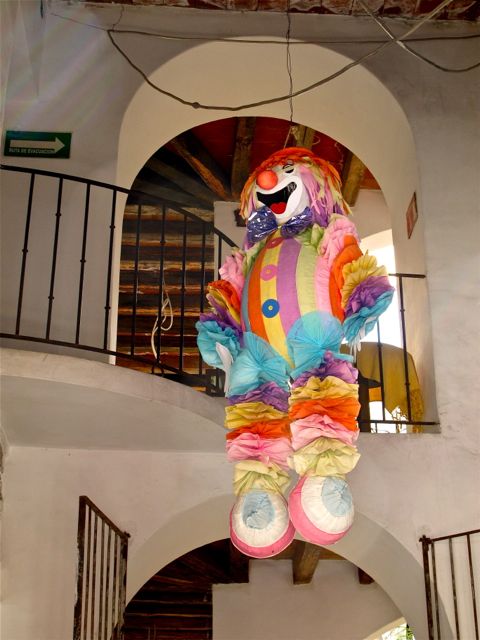 Clown piñata hanging from a ceiling