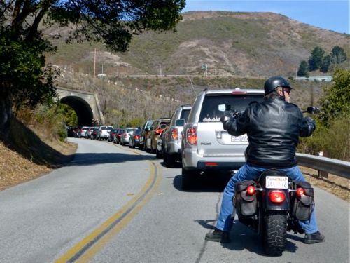 Cars and motorcycle waiting to go through tunnel of Marin Headlands.