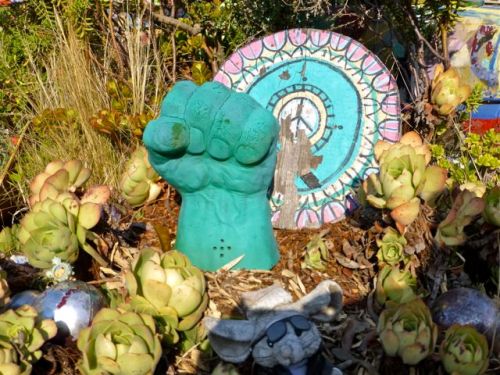 Found objects with clenched fist and peace symbol.