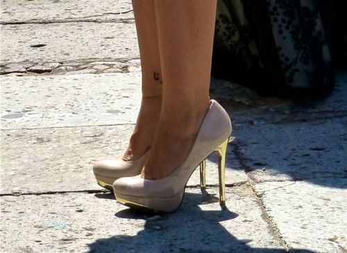 lower legs of woman wearing 4+ inch high heels