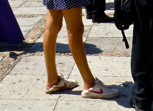 Lower legs of a young woman wearing gym shoes