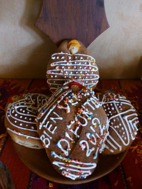 Four small loaves of decorated bread