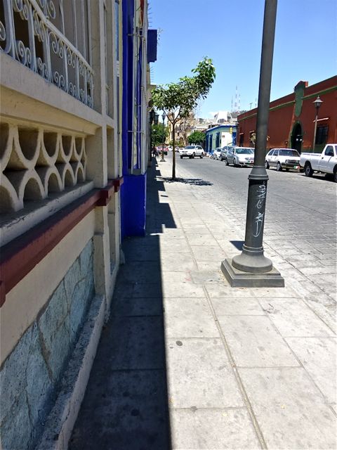 Empty sidewalk with sliver of shade