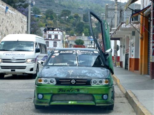 Green Nissan with a Lambo door