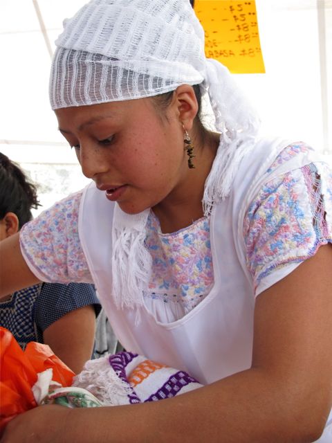 Conductor and band in front of large banner