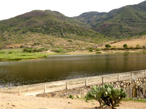 Dam, reservoir, and mountains