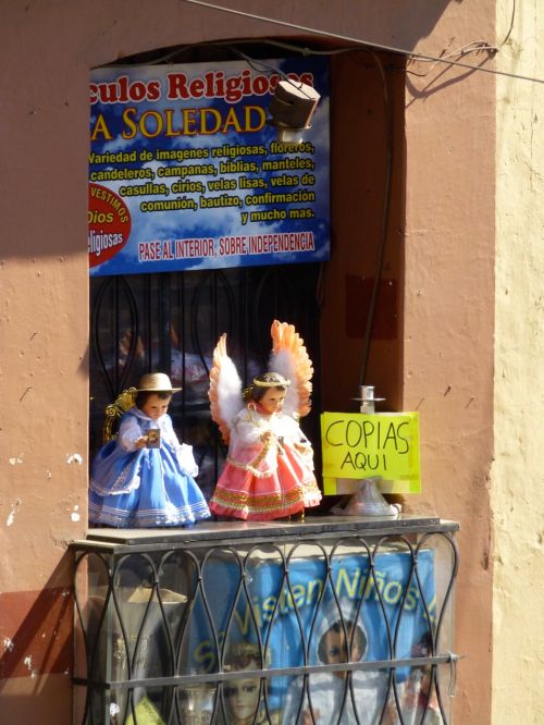 2 Niño Dios in window of store