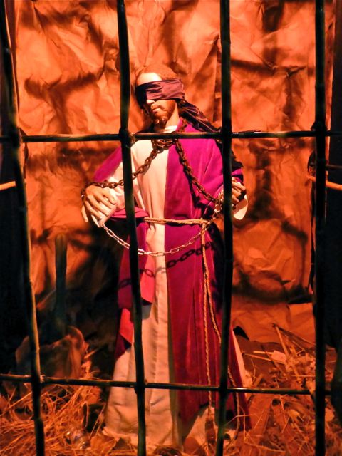 Blindfolded Jesus behind bars