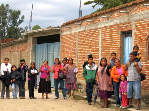 Men, women, and children standing on street