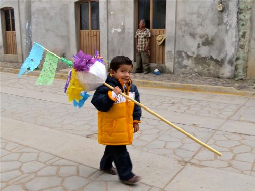 Little boy carrying small marmota 