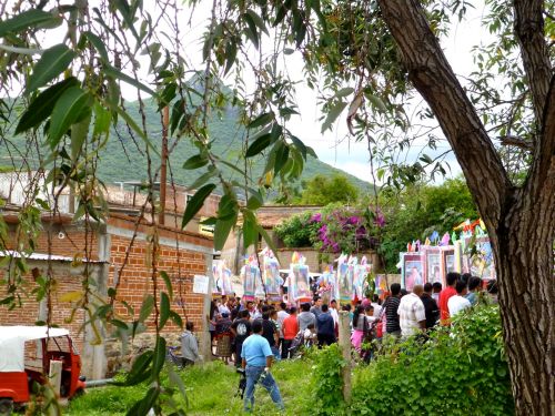 Procession in mid-ground and mountain in background