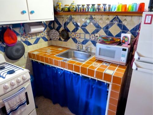 Russet orange tile counter with accent tiles. 