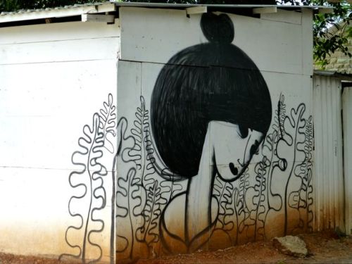 Tranquil female face painted on side of building