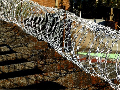 Coiled razor wire on roof