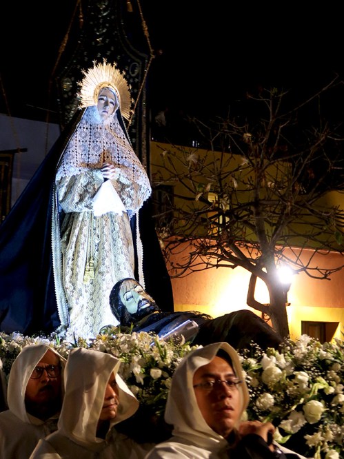 Virgen de los Dolores standing above prone Jesus images